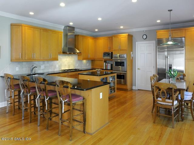 10 Tyler Lane Riverside, CT 06878 - Photo 9 of 25 a kitchen with stainless steel appliances granite countertop dining table chairs sink and wooden floor