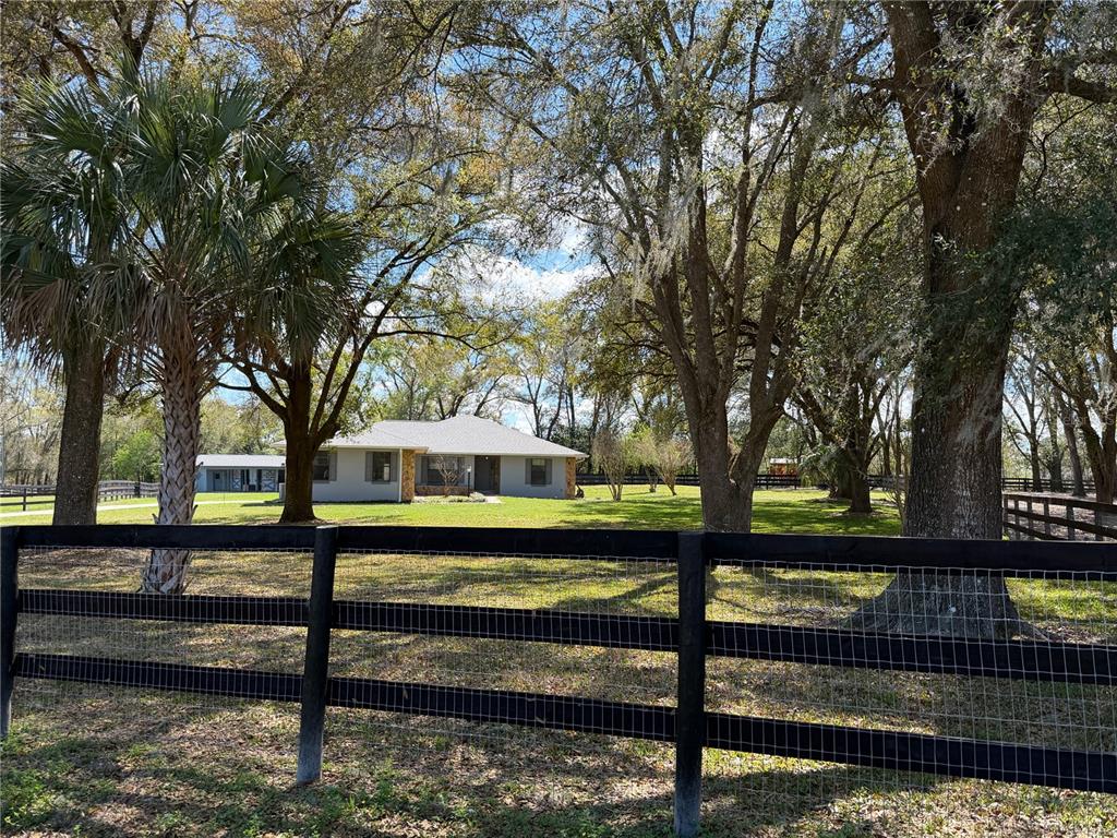 10 Carry Back Road Ocala, FL 34482 - Photo 1 of 69 a view of a yard with wooden fence