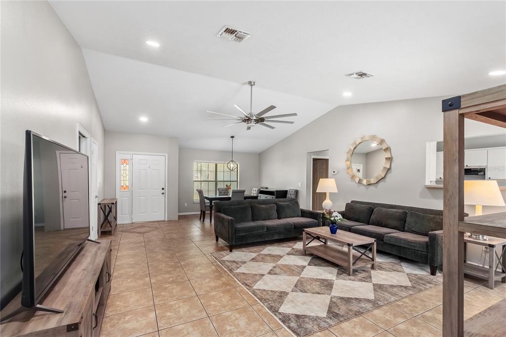 10 Carry Back Road Ocala, FL 34482 - Photo 16 of 69 a living room with furniture a large window and a clock