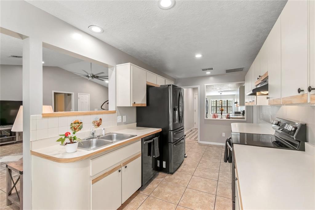 10 Carry Back Road Ocala, FL 34482 - Photo 20 of 69 a kitchen with stainless steel appliances a sink a stove a refrigerator and cabinets