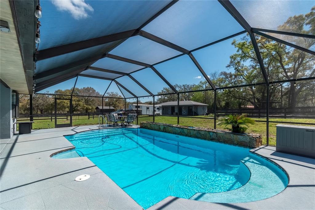 10 Carry Back Road Ocala, FL 34482 - Photo 41 of 69 a view of a swimming pool with a porch