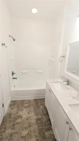a bathroom with a granite countertop sink a toilet and bathtub