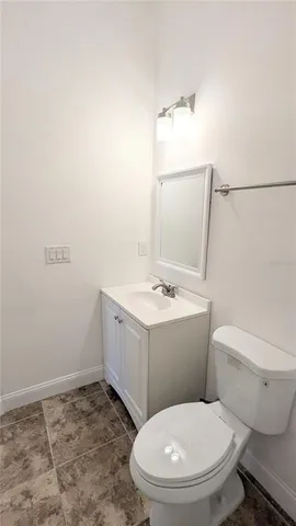 a white toilet sitting next to a bathroom sink
