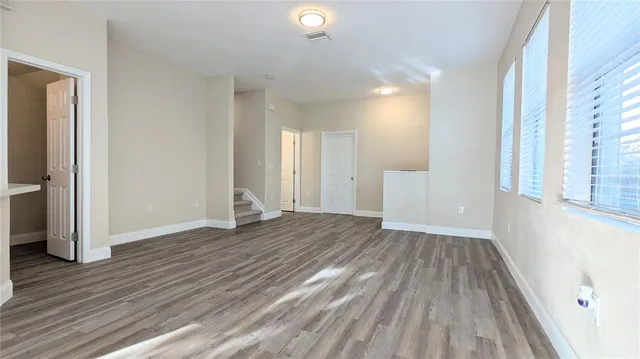 wooden floor in an empty room with a window