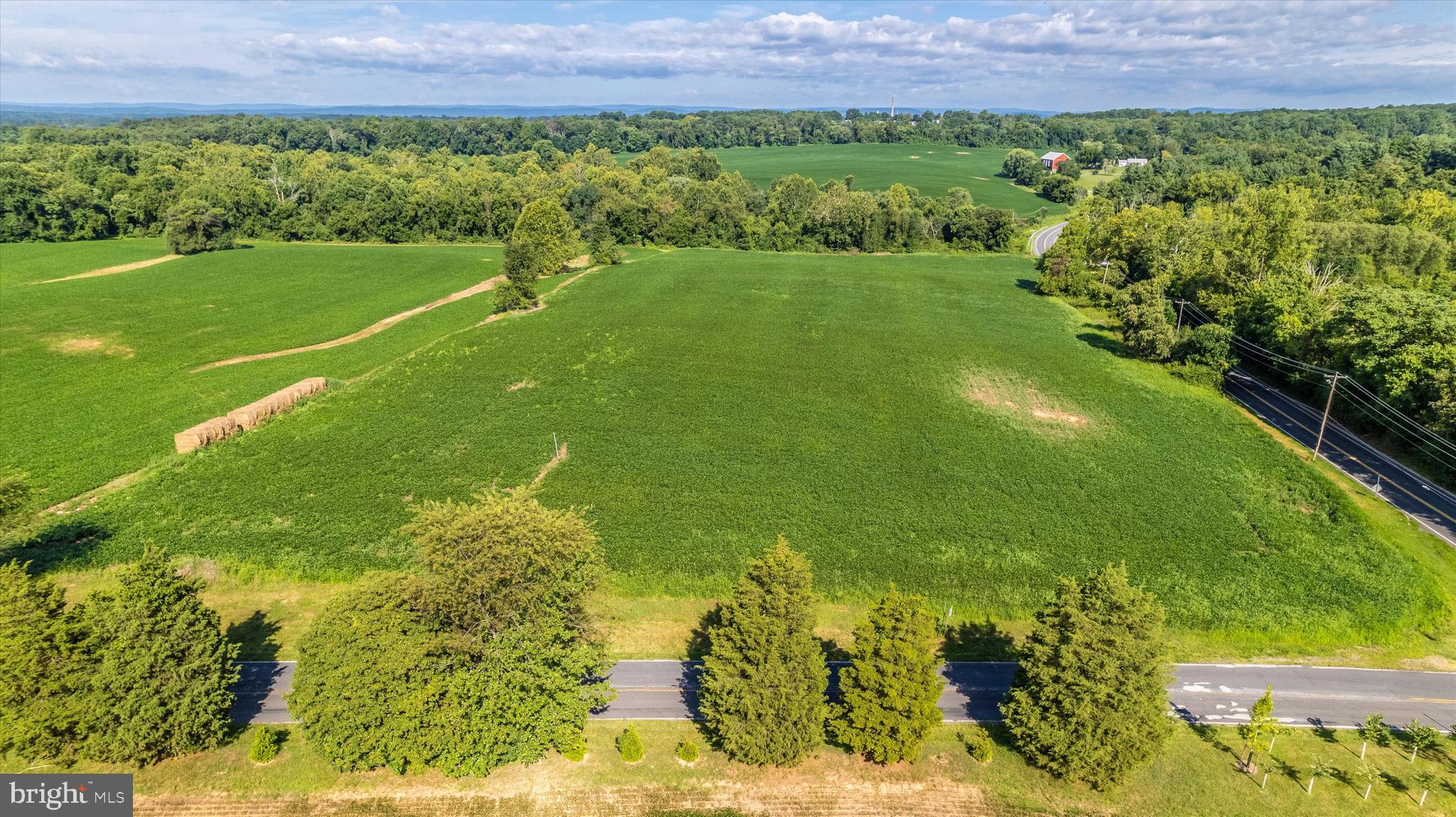 19101 Darnestown Road Poolesville, MD 20837 - Photo 16 of 29 a view of a garden with a building in the background