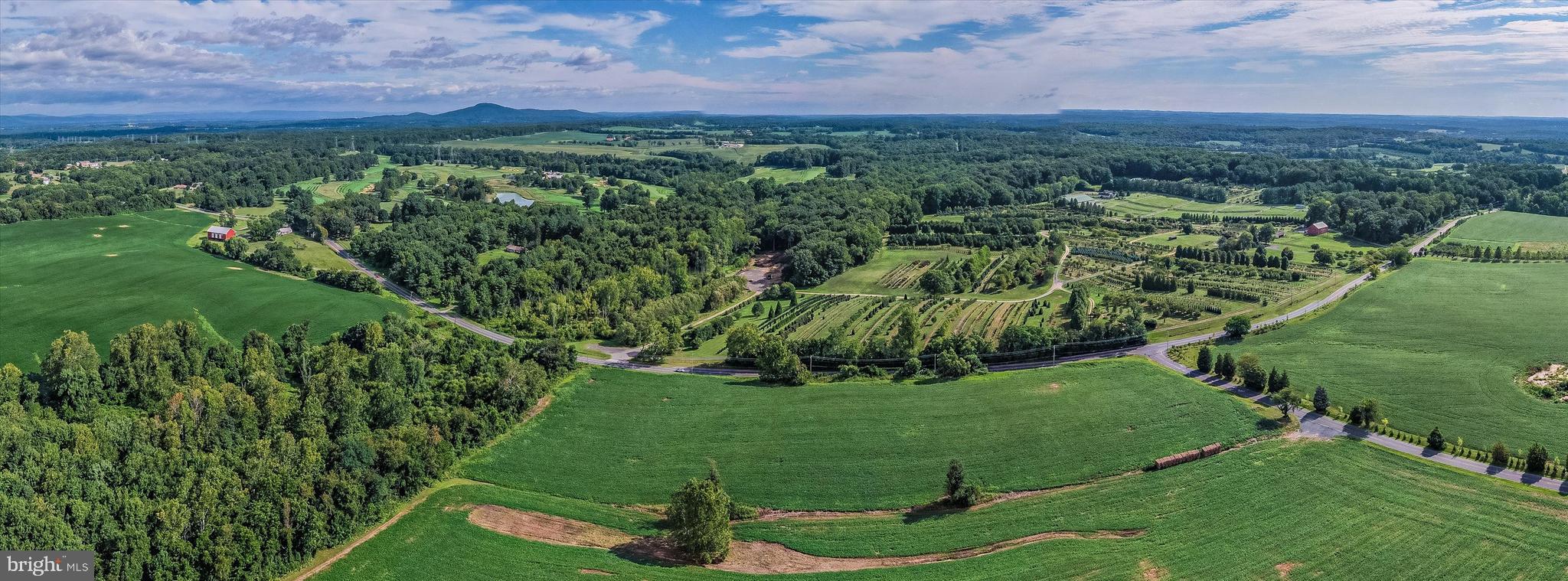 19101 Darnestown Road Poolesville, MD 20837 - Photo 29 of 29 a view of a garden with a building in the background