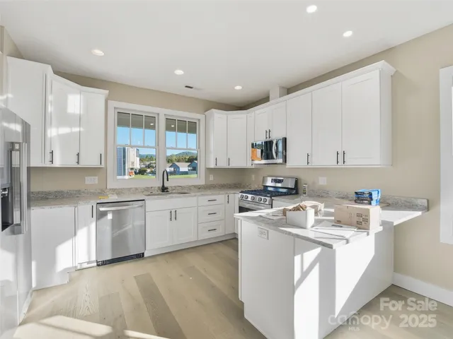 a kitchen with a sink stove cabinets and refrigerator