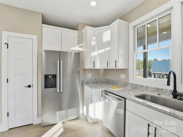 a kitchen with a sink stove and refrigerator
