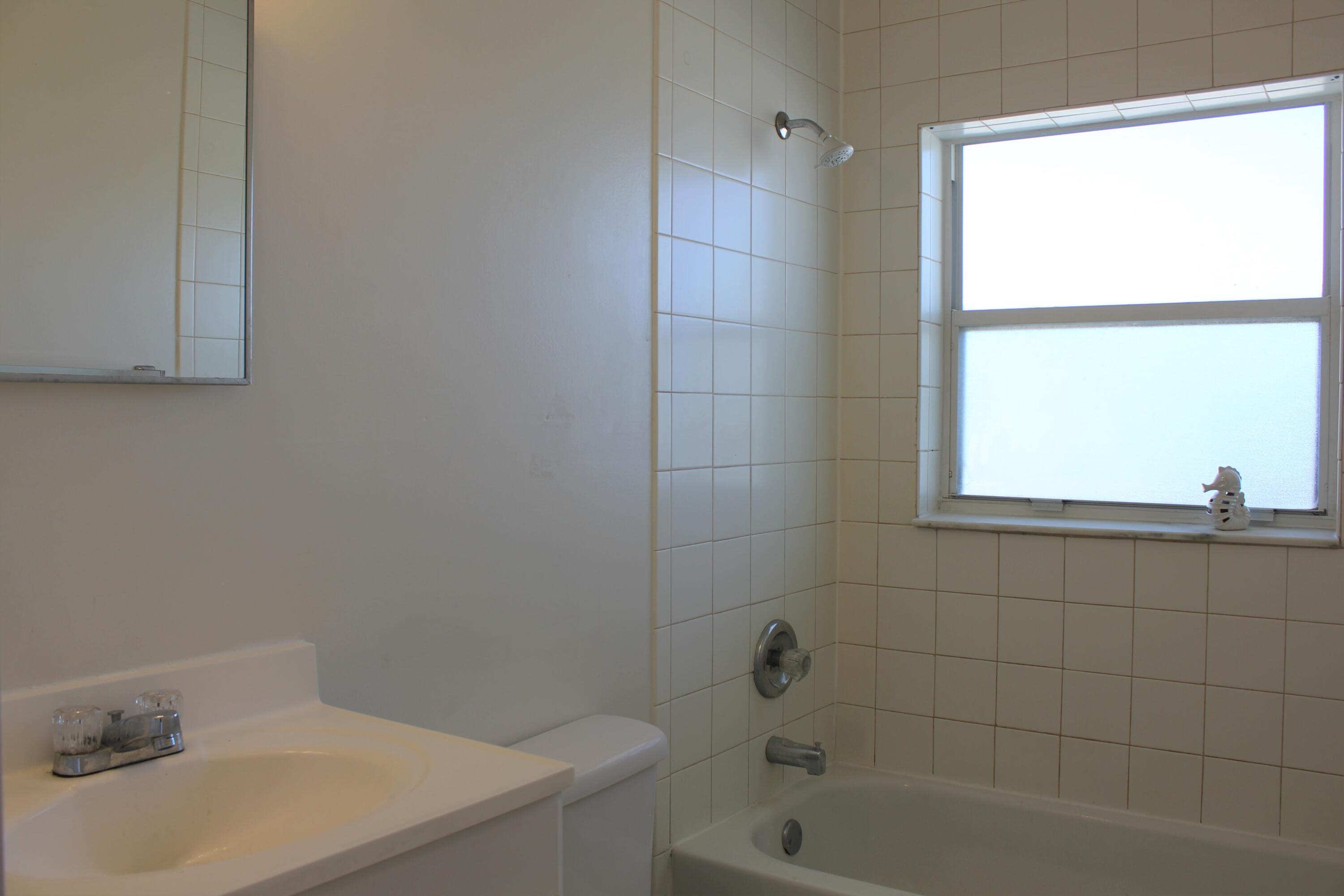 651 Palm Drive, Unit A4 Satellite Beach, FL 32937 - Photo 13 of 16 a bathroom with a sink and a bathtub