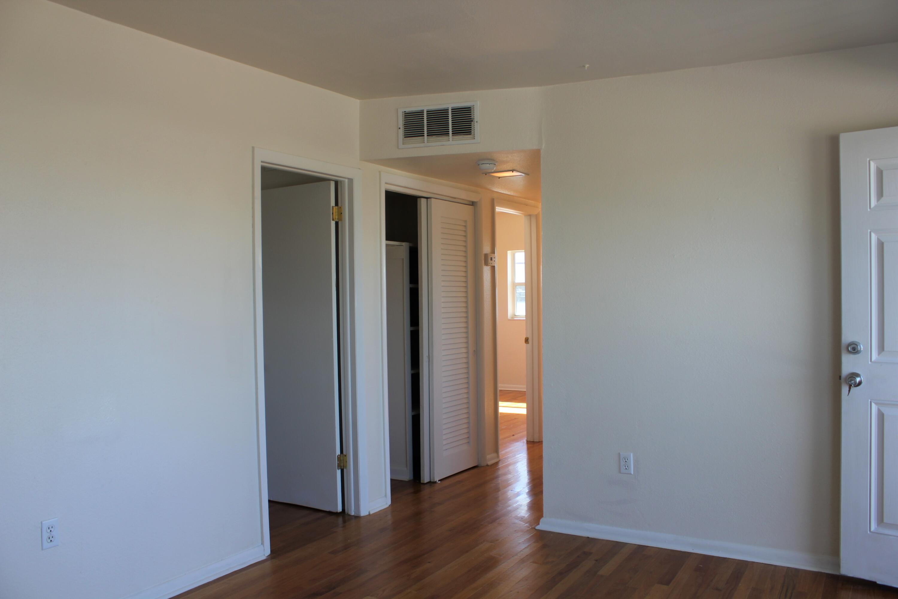 651 Palm Drive, Unit A4 Satellite Beach, FL 32937 - Photo 3 of 16 an empty room with wooden floor and windows