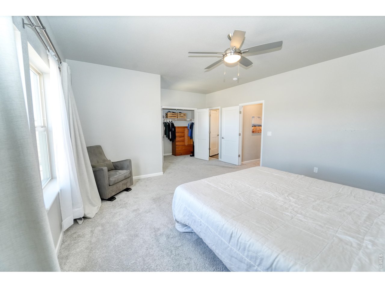 13388 Positano Point Colorado Springs, CO 80921 - Photo 12 of 26 a bedroom with a bed and a chandelier