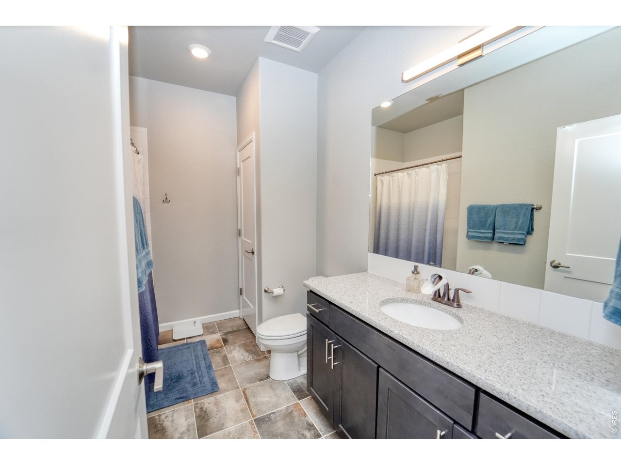 13388 Positano Point Colorado Springs, CO 80921 - Photo 18 of 26 a bathroom with a sink vanity granite and a mirror