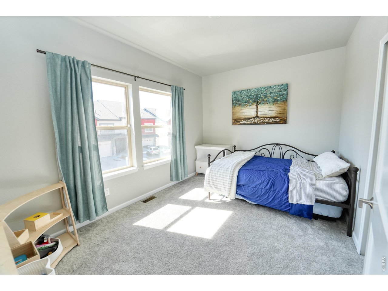 13388 Positano Point Colorado Springs, CO 80921 - Photo 20 of 26 a spacious bedroom with a bed and a painting on the wall