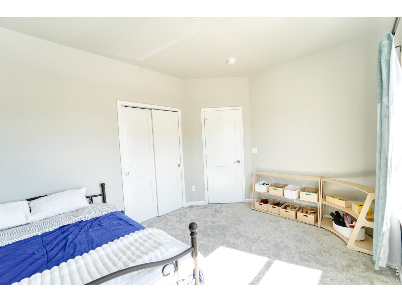 13388 Positano Point Colorado Springs, CO 80921 - Photo 21 of 26 a bedroom with a bed and a cabinets