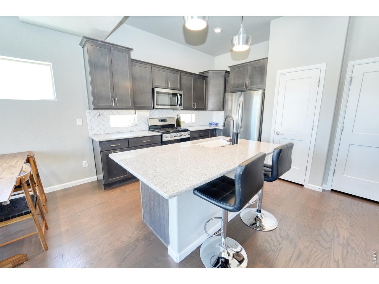 13388 Positano Point Colorado Springs, CO 80921 - Photo 5 of 26 a kitchen with kitchen island a sink appliances and cabinets
