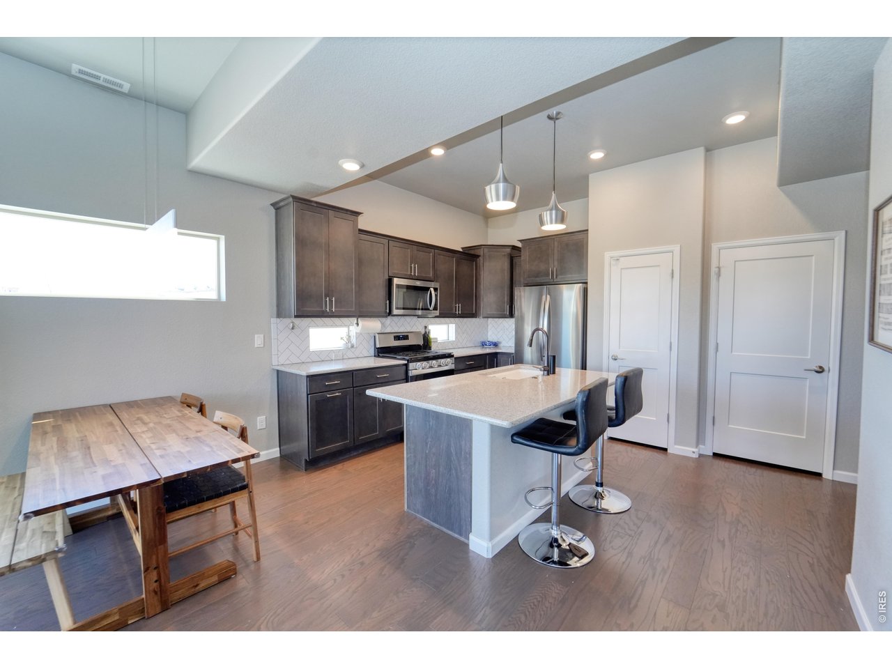 13388 Positano Point Colorado Springs, CO 80921 - Photo 6 of 26 a kitchen with kitchen island stainless steel appliances sink cabinets and stove