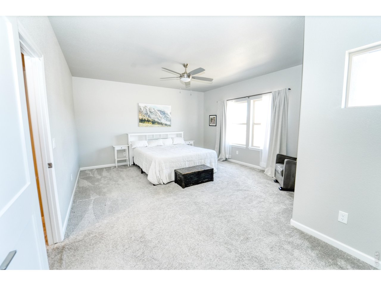 13388 Positano Point Colorado Springs, CO 80921 - Photo 10 of 26 a spacious bedroom with a bed and a ceiling fan