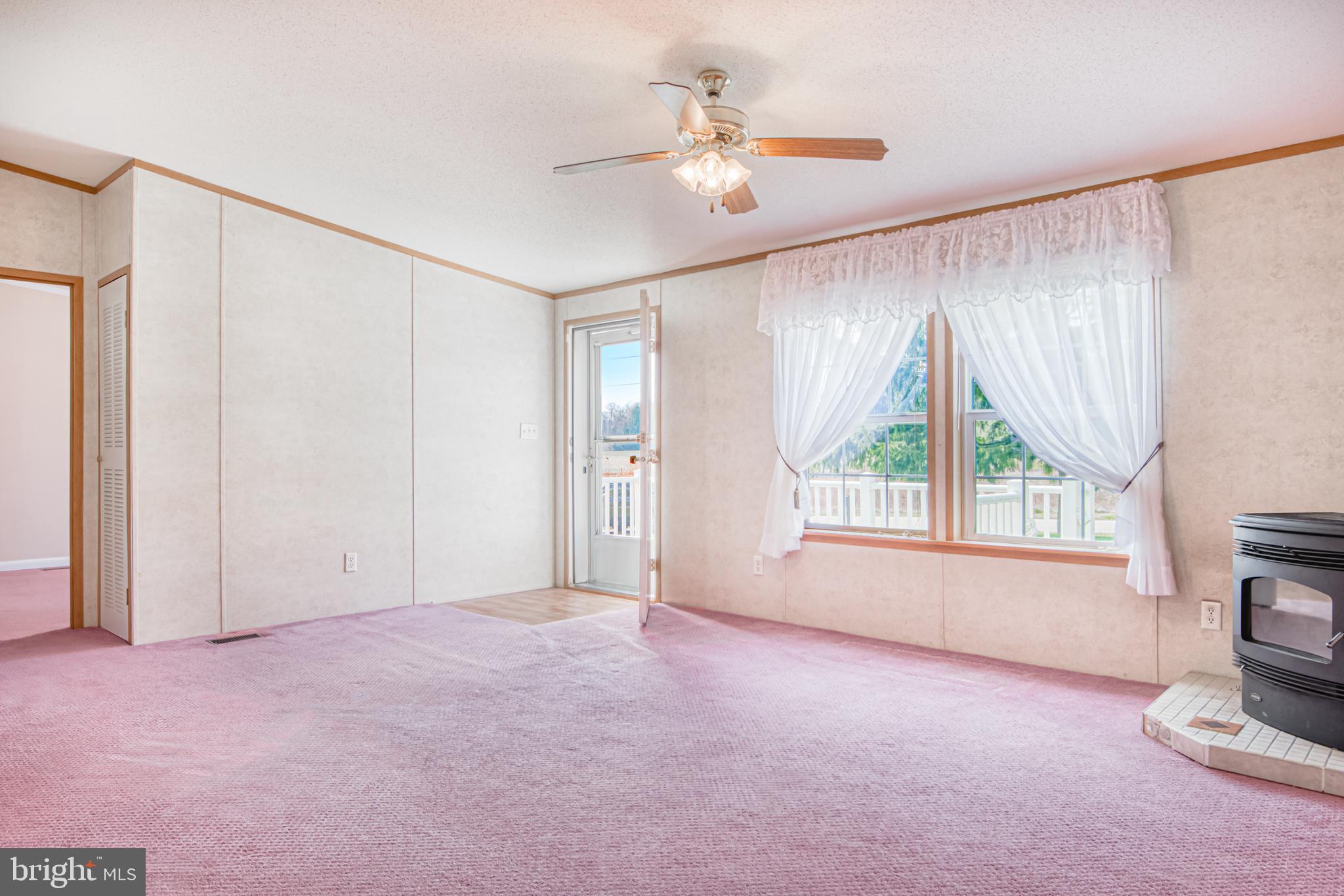 12843 Center Road Stewartstown, PA 17363 - Photo 5 of 28 Living Room with Vaulted Ceiling and Pellet Stove