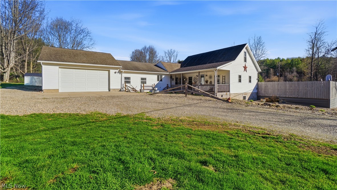 65892 Endley Road Cambridge, OH 43725 - Photo 8 of 50 View of front facade with gravel driveway, a garage, and covered porch