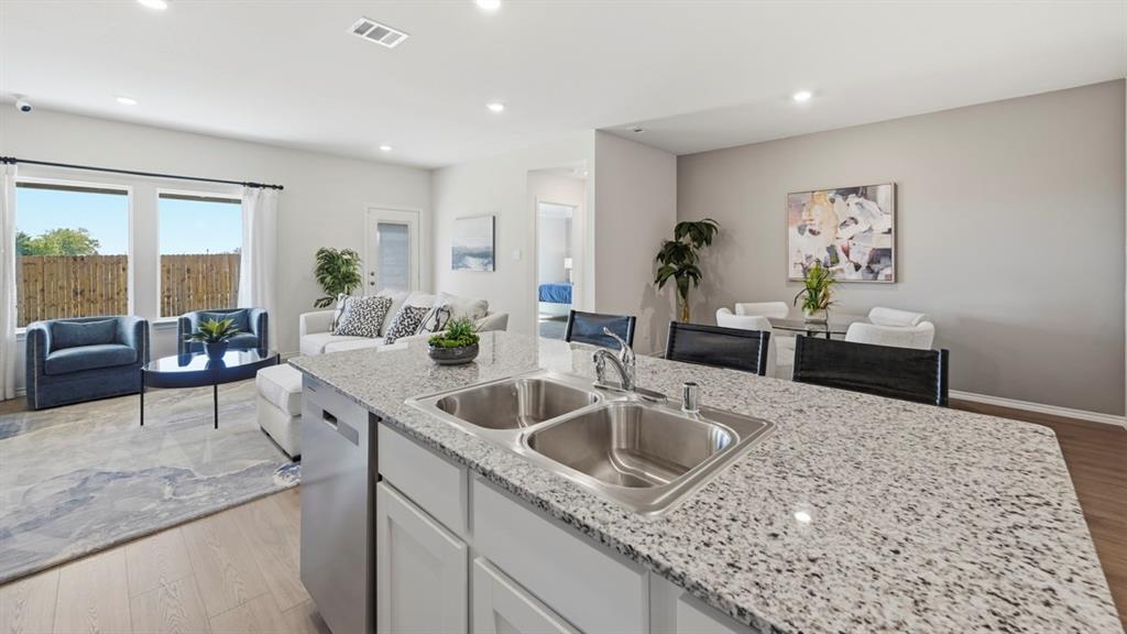 3427 Spur Run Sherman, TX 75090 - Photo 22 of 36 a kitchen with sink cabinets and living room