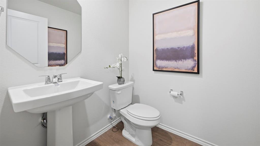 3427 Spur Run Sherman, TX 75090 - Photo 3 of 36 a bathroom with a toilet a sink and mirror