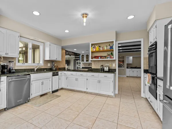 a kitchen with a refrigerator and cabinets