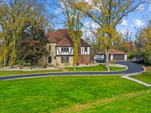 a front view of a house with a yard table and chairs