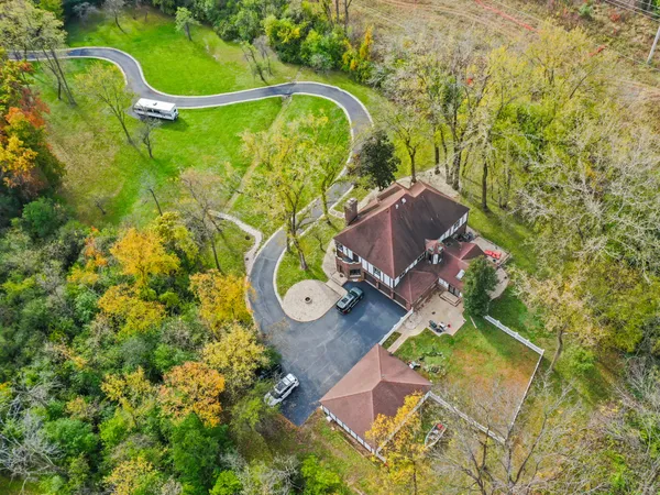 an aerial view of a house with a swimming pool