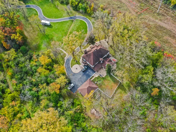 an aerial view of a house with a backyard space and street view