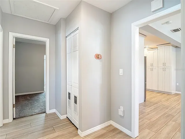 a view of a hallway with wooden floor
