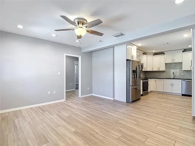 a view of a kitchen with a sink and stainless steel appliances