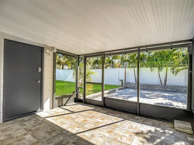 a bedroom with a bed and glass door