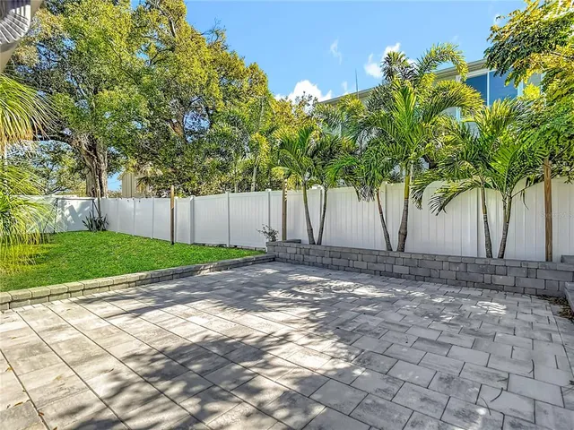 a view of a backyard with large trees