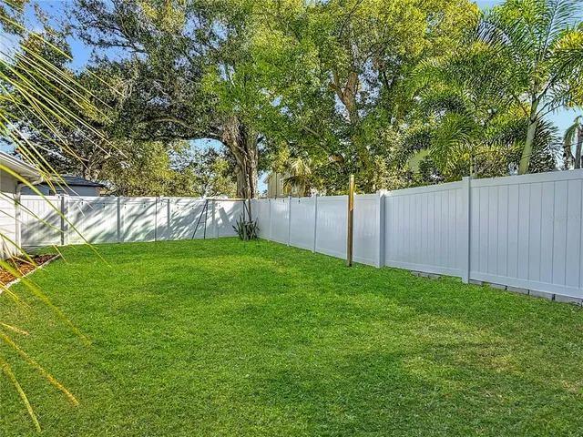 a view of yard with grass and trees