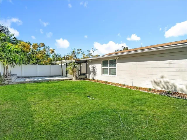 a view of a house with a backyard