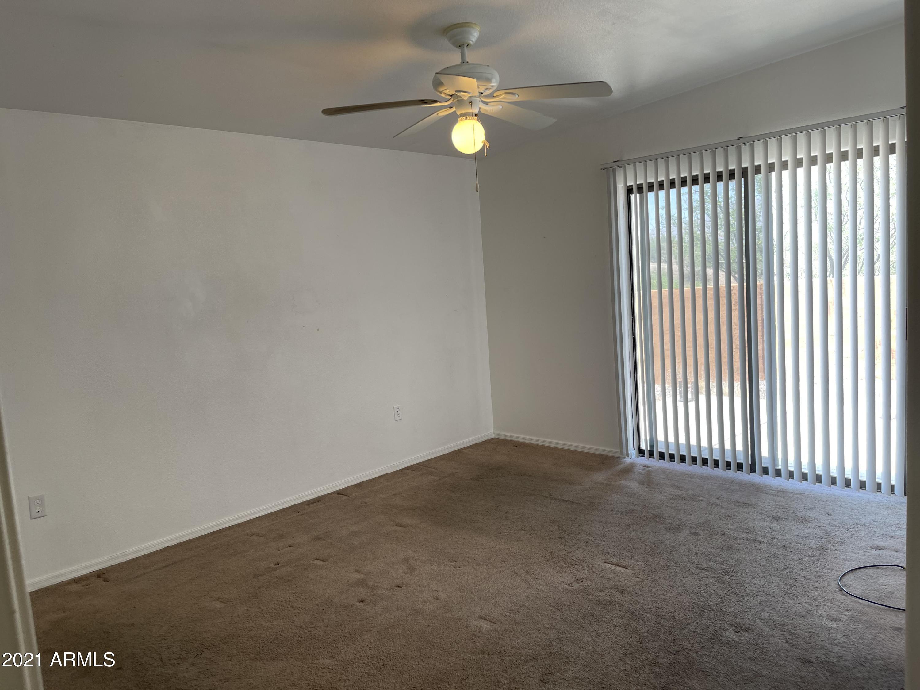 1022 Circulo Golondrina, Unit B Rio Rico, AZ 85648 - Photo 12 of 20 wooden floor in an empty room with a window