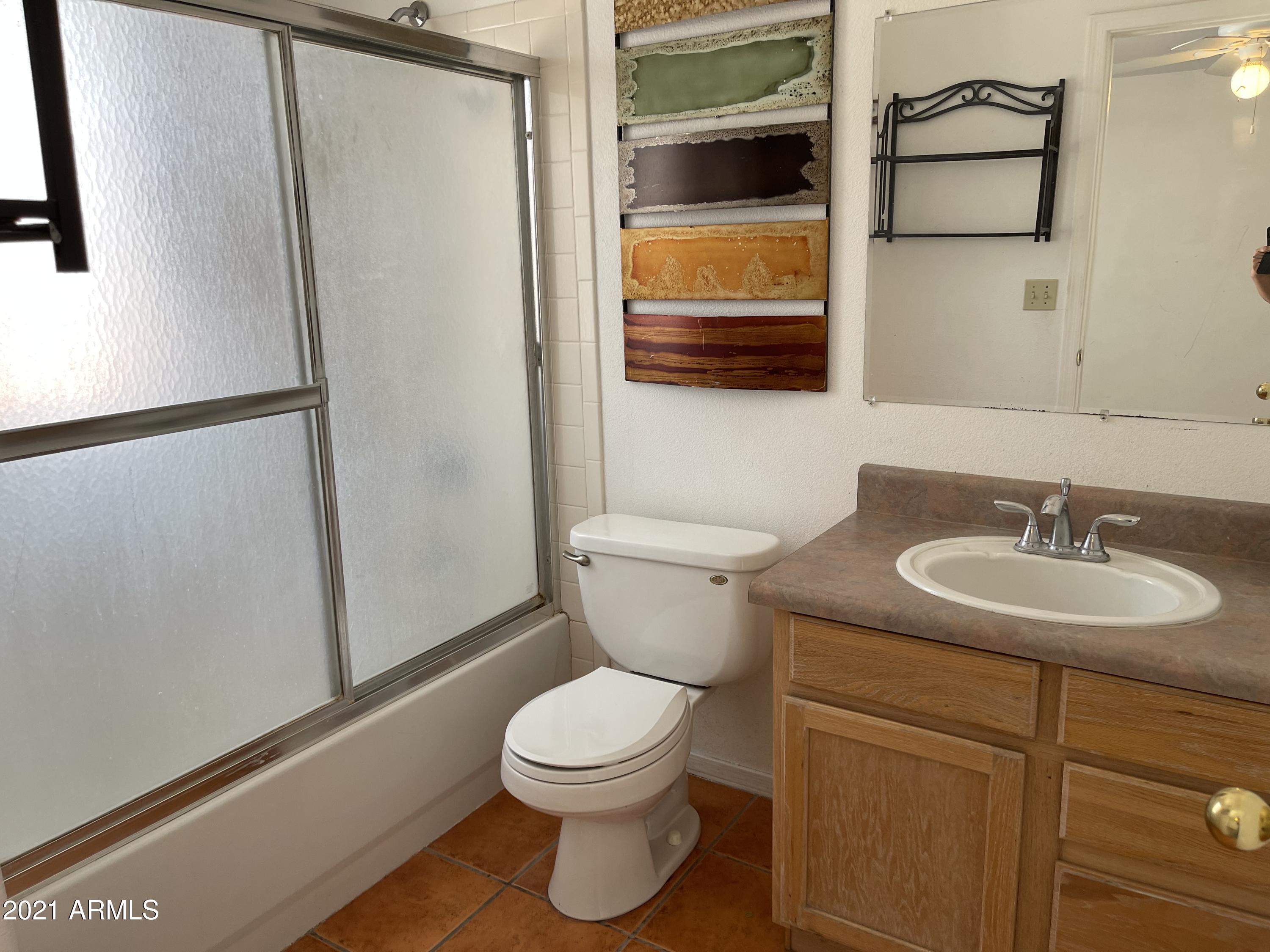 1022 Circulo Golondrina, Unit B Rio Rico, AZ 85648 - Photo 13 of 20 a bathroom with a toilet sink and mirror