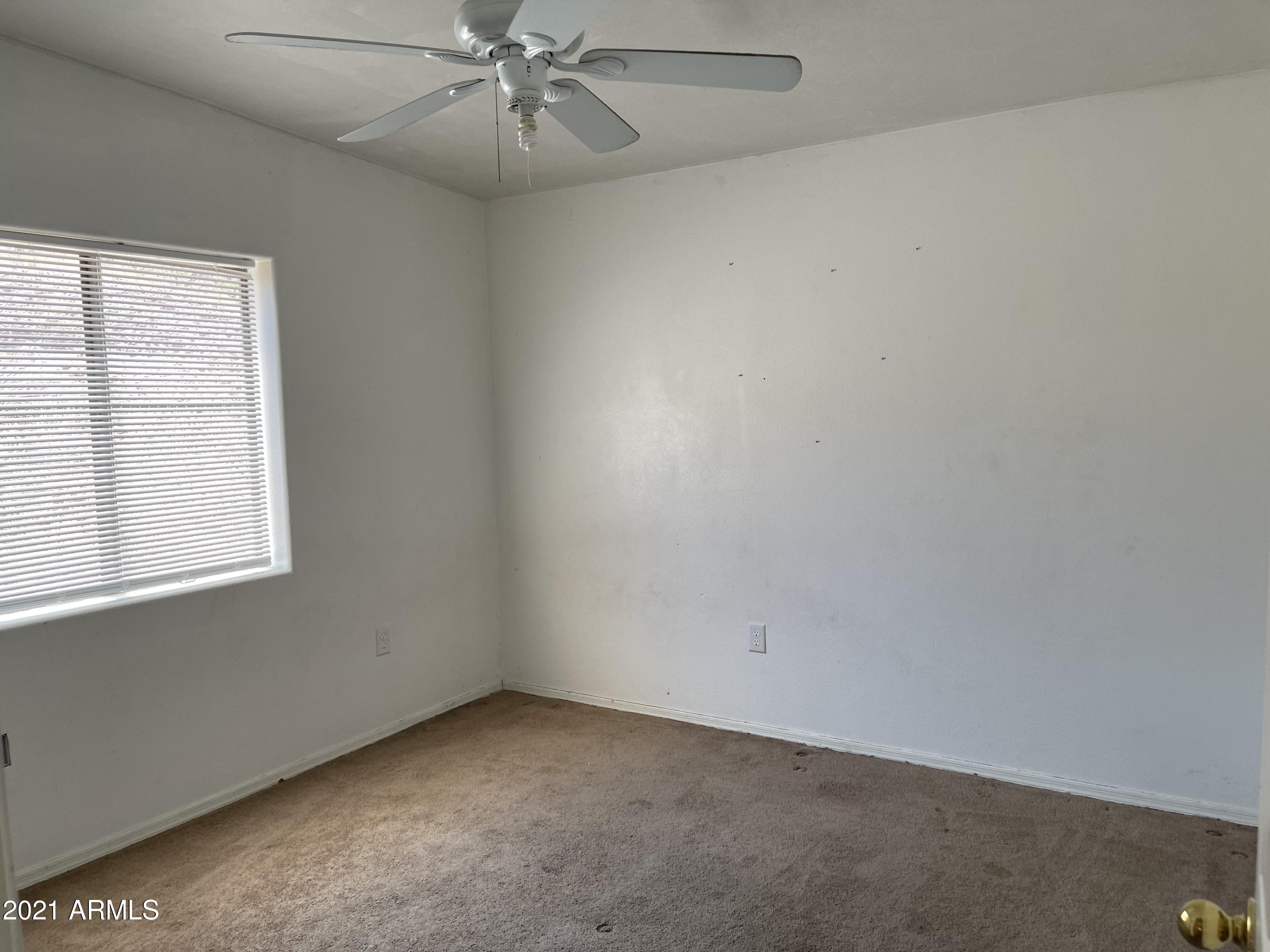 1022 Circulo Golondrina, Unit B Rio Rico, AZ 85648 - Photo 15 of 20 an empty room with a window and a fan