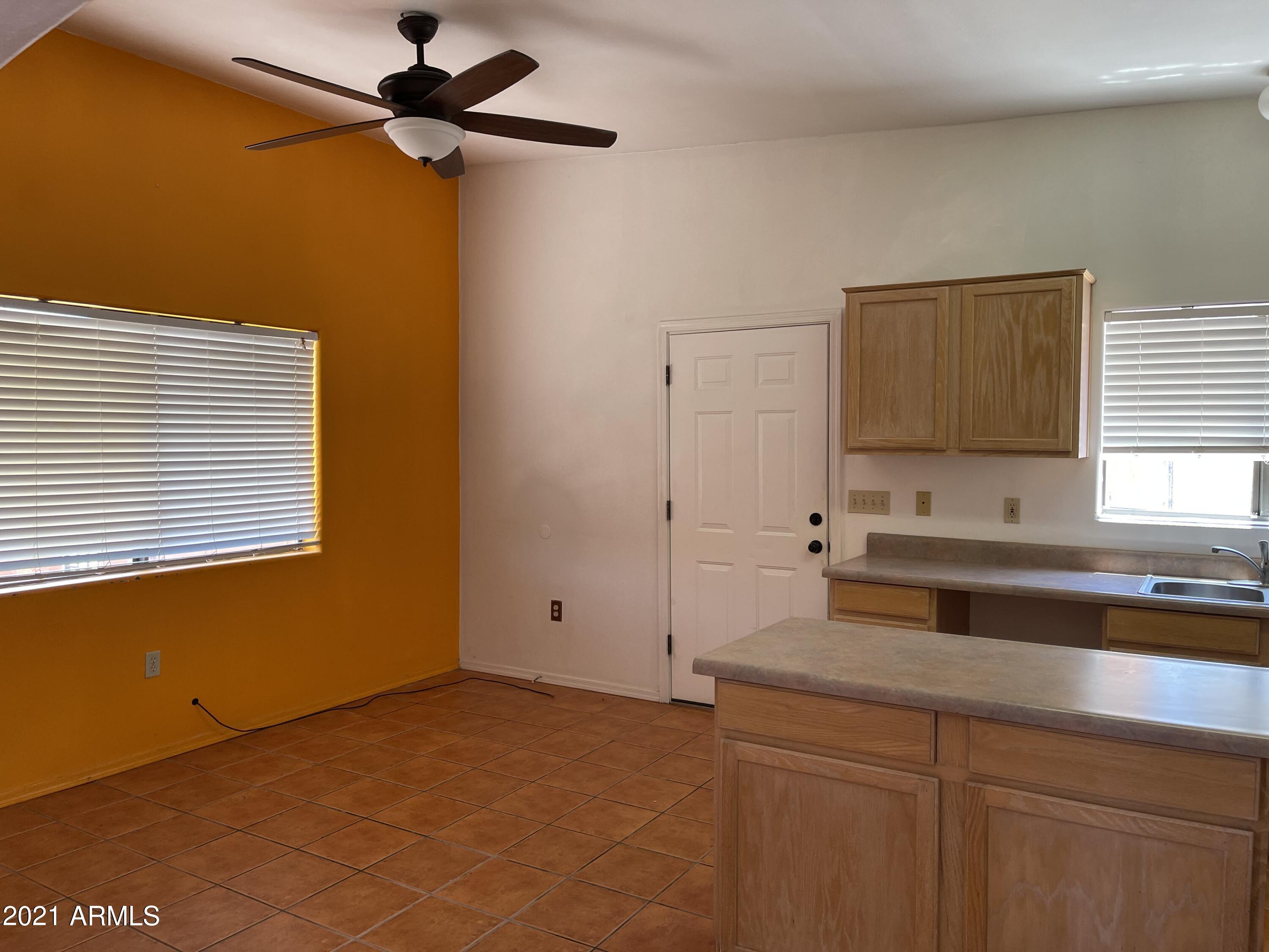 1022 Circulo Golondrina, Unit B Rio Rico, AZ 85648 - Photo 8 of 20 a kitchen with a sink cabinets and a window