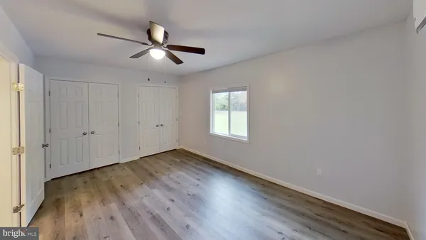 a view of a kitchen with wooden floor and electronic appliances