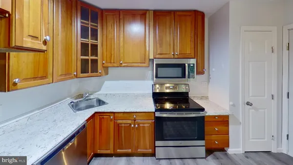a kitchen with a sink a microwave a dining table and chair