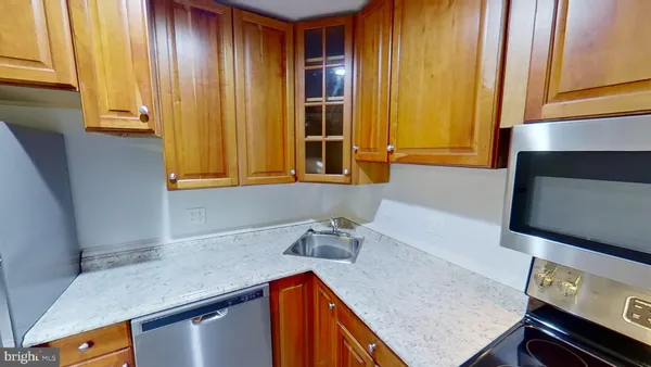 a kitchen with stainless steel appliances granite countertop cabinets and wooden floor