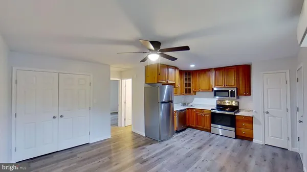 a view of empty room with wooden floor and window