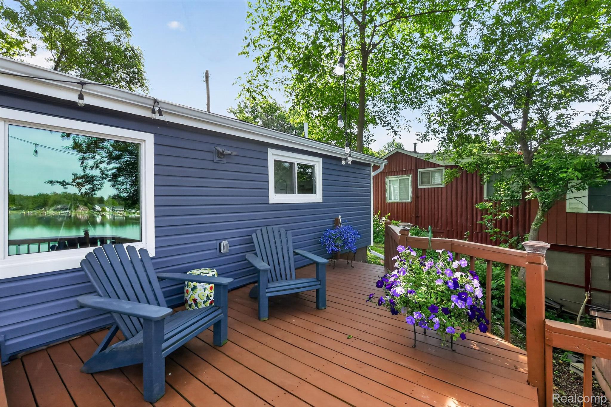 1717 Triangle Lake Road Howell, MI 48843 - Photo 6 of 58 Expansive wood deck with a stained finish and surrounding railing