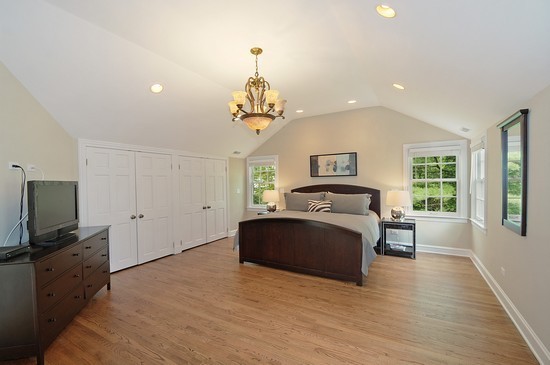 590 Sheridan Road Winnetka, IL 60093 - Photo 11 of 16 a spacious bedroom with a bed and a flat screen tv