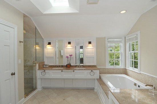 590 Sheridan Road Winnetka, IL 60093 - Photo 12 of 16 a bathroom with a bathtub a double vanity sink and mirror with bathtub