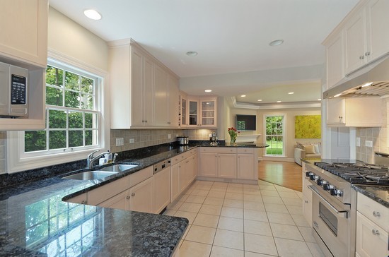 590 Sheridan Road Winnetka, IL 60093 - Photo 4 of 16 a large kitchen with stainless steel appliances granite countertop a stove a sink and a granite counter tops