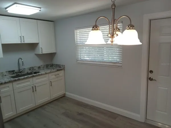 a kitchen with a sink cabinets and window