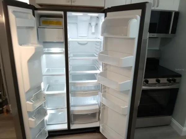 a refrigerator freezer sitting inside of a kitchen