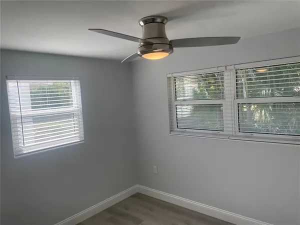 a view of empty room with ceiling fan